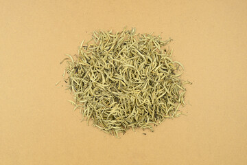 white tea. silver needles tea. heap of dry leaves of white tea on a background of brown kraft paper