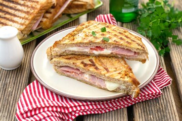Grilled sandwich with ham, mozzarella cheese and tomato