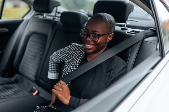 African American Businesswoman Is Putting Seatbelt On.