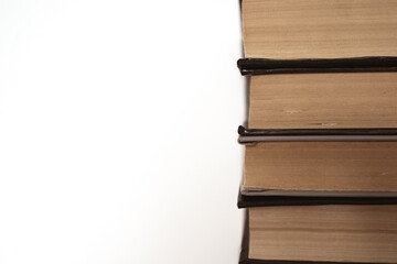 stack of books on white background copy space. Old books