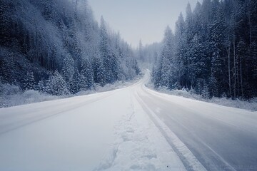 Fototapeta na wymiar Scenic winter dangerous icy slippery winding highway road with piles of snow on the side of the road after clearing the road and snow covered mountains overgrown with spruce forest in Montana