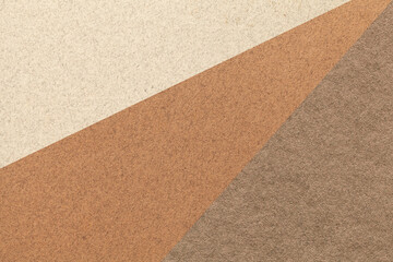 Texture of old craft beige, brown and umber color paper background, macro. Structure of vintage abstract cardboard