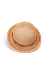 Fototapeta na wymiar Close-up shot of a women's beige woven bowler hat with a brown ribbon and a bow. The curved-brim woven summer hat is isolated on a white background. Top view.