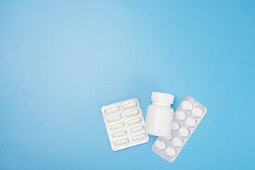 delivery from the pharmacy, pills in blister packs on a blue background with copy space