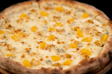 Sweet dessert pizza or brazilian pizza with peach, nuts and gorgonzola cheese on wooden background, top view. ready for pizza menu design.