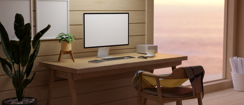 Comfy wooden workspace with blank screen PC desktop computer on wooden table and stationary