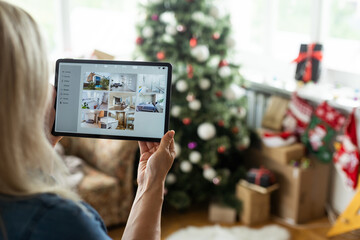 Hand holding a tablet with smart home system applications, digital tablet in christmas day