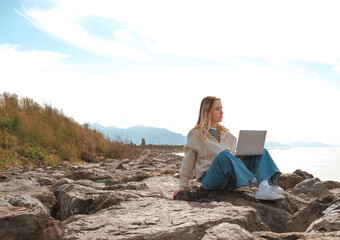 Remote work.Girl freelancer works remotely on the sea shore. workation, remote work,WFVH,Van Life vibes work from vacation home,work travel,remotely work.Travelling.Work from vacation remotely