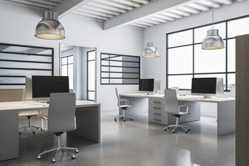 Clean coworking interior with various pieces of furniture and items, window with city view and daylight.