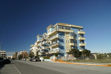 Ostia, Rome, Italy - October 10, 2022, three isolated buildings on the sea front.