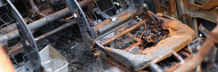Car after fire, iron parts of burnt vehicle - obrazy, fototapety, plakaty