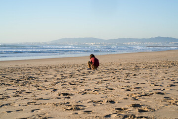 A kid playing on the beach