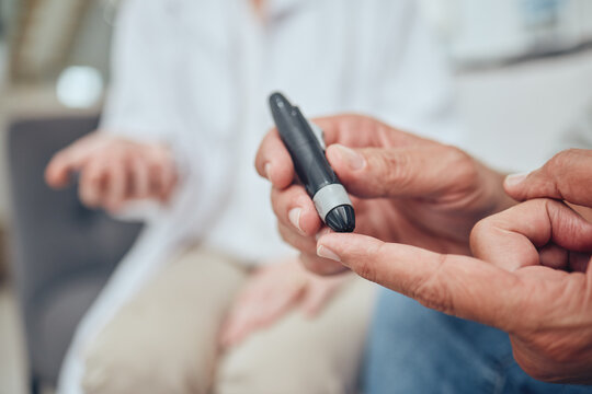Finger, healthcare and diabetes with a senior man testing his blood sugar level while in his retirement home. Medical, wellness and test with a mature male using a glucometer to measure his glucose