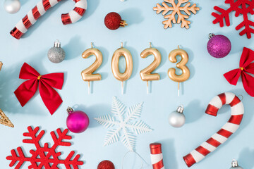Creative New Year party concept background. Christmas decoration, fireworks and confetti. Happy 2023.