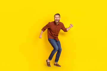 Fototapeta na wymiar Full size portrait of overjoyed cheerful man chilling dancing clubbing isolated on yellow color background