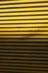 Fototapeta premium yellow metal shutter background with stripes