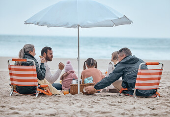 Family, beach food and relax on holiday, vacation or trip outdoors on sandy seashore. Back view,...