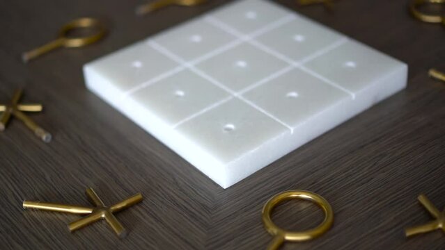 Close-up of tic-tac-toe made of metal and stone