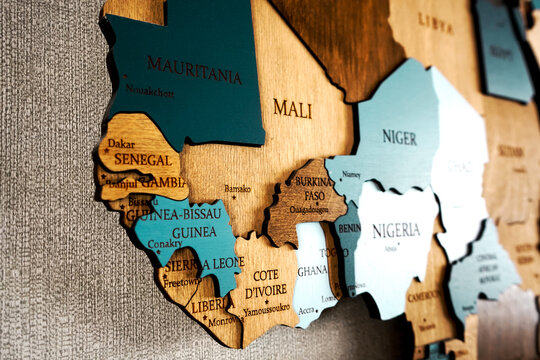 West Africa, Mali, Senegal, Guinea, Cote d'ivoire, Ghana, Liberia, Benin on wooden world map. Political color interior map of the world with countries on the wall.