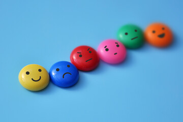 A variety of human emotions: joy, serenity, anger, sadness on colored balls
