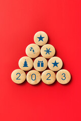 Wooden balls in the form of a Christmas tree with drawings of Christmas icons on it. The new year...