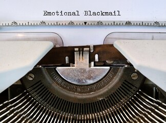 Vintage typewriter with typed text Emotional Blackmail, refers to manipulation where someone uses victim feelings to control behavior or  use tactics to make that person feel guilty 