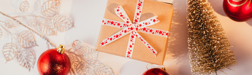 Banner with Christmas gift and decorations on background.