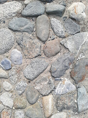 Top view of a fragment of a dirt road. Rubble stones of different fractions on the ground. Abstract natural textured background. Drainage layer.