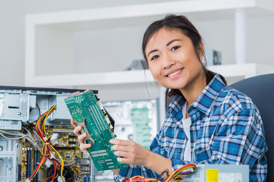 young woman fixing a computer