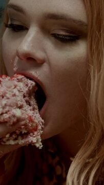 A ginger head girl eating cake with hands