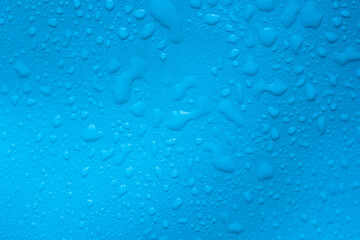 Water drops on a blue leather surface as an abstract background