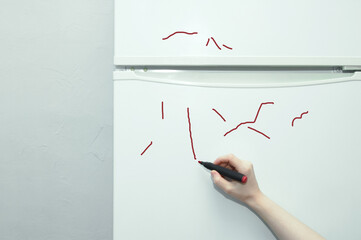 Painted refrigerator. Marker strokes. Marker in  child hand.