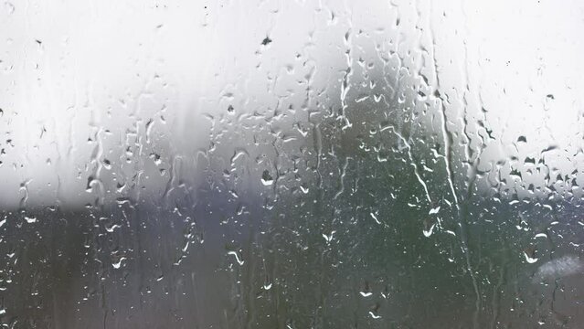 Blurred window view of wet weather outside, background for text
