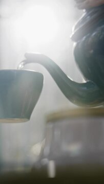 Close up of tea being poured into a cup