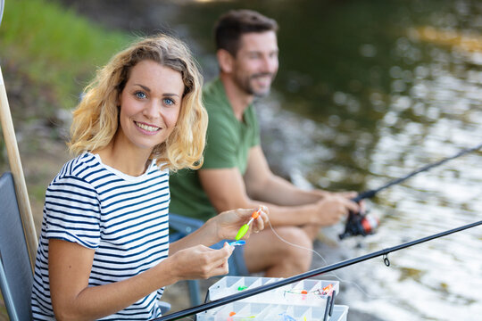 Peaceful Young Couple Fishing By The Pond