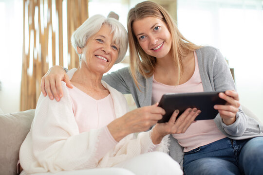 mother and daughter use tablet at home