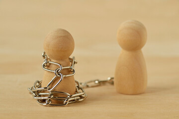 Wooden pawn with chains controlled by his partner - Concept of toxic relationship, love, domination and control - 544572491