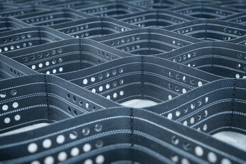 Polymeric geogrid with a three-dimensional structure to keep the soil from sliding down the slope.