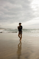 girl walking in winter on a beach in  portugal