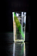cocktail with Gin, lime-mint cordial, ginger ale in glass on black background