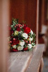 Lush beautiful bouquet with roses, eucalyptus, eustoma, lies on a  wooden window