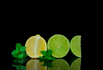 Still life, lemon and lime on black background