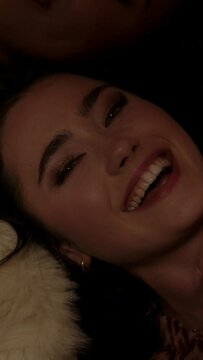 Close up of a girl lying on the floor dancing and winking at the camera