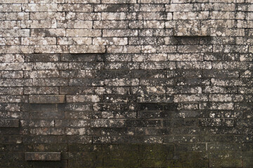 Balinese brick wall texture, stained moss brick wall, irregular pattern,  protruding bricks, 