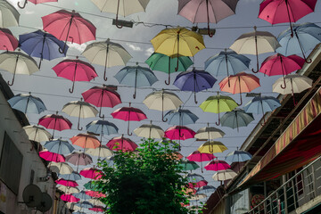 Fototapeta na wymiar Antalya, Turkey - October 20, 2022 - Street umbrellas with lots of cafes