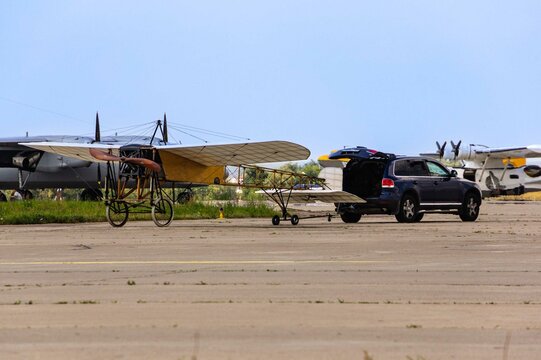 Retro aviation. World War I. French Bleriot XI reconnaissance aircraft being towed by SUV to  parking lot. Celebrating 100th anniversary of Russian Air Force.  Zhukovsky, Russia - August 12, 2012