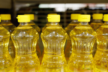 vegetable oil in plastic bottles on shelf in supermarket store. cooking oil, palm oil.
