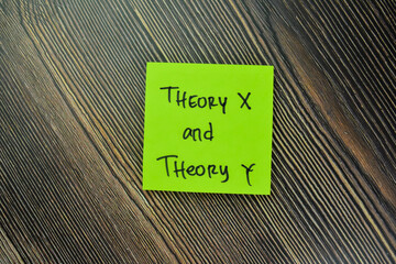 Concept of Theory X and Theory Y write on sticky notes isolated on Wooden Table.