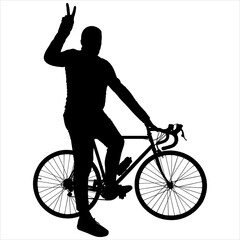 The cyclist poses for the camera. The man and the bicycle are sideways. The guy is standing near the bike, holding the steering wheel with one hand; the second hand shows the gesture of 