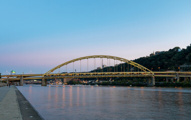 Fototapeta na wymiar Fort Pitt Bridge and Monongahela River in Pittsburgh in Pennsylvania. Sunset Sky and Light.